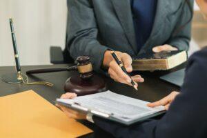 A lawyer meeting with a client who is asking how to file a lawsuit even if you have no money.