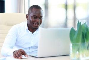 A man using his computer to determine if he can get a loan on a car accident settlement.