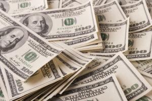 A pile of money showing the possibility of same-day pre-settlement funding.