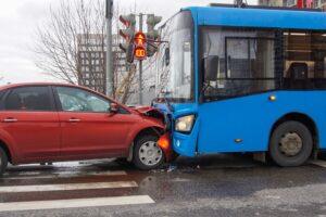 A red car crashed head-on into the front of a blue bus, leaving accident victims to wonder how much their bus accident settlement will be worth.