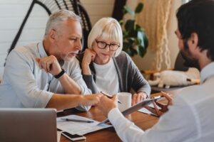 Two people meet with their attorney to learn the differences between Pegasus Legal Capital vs. Oasis Financial. Which is right for you?
