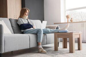 Injury victim uses computer to research if lawyers get paid before medical bills.