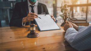 Attorney presenting a settlement offer to their client, with the client wondering how long their lawyer can hold a settlement check